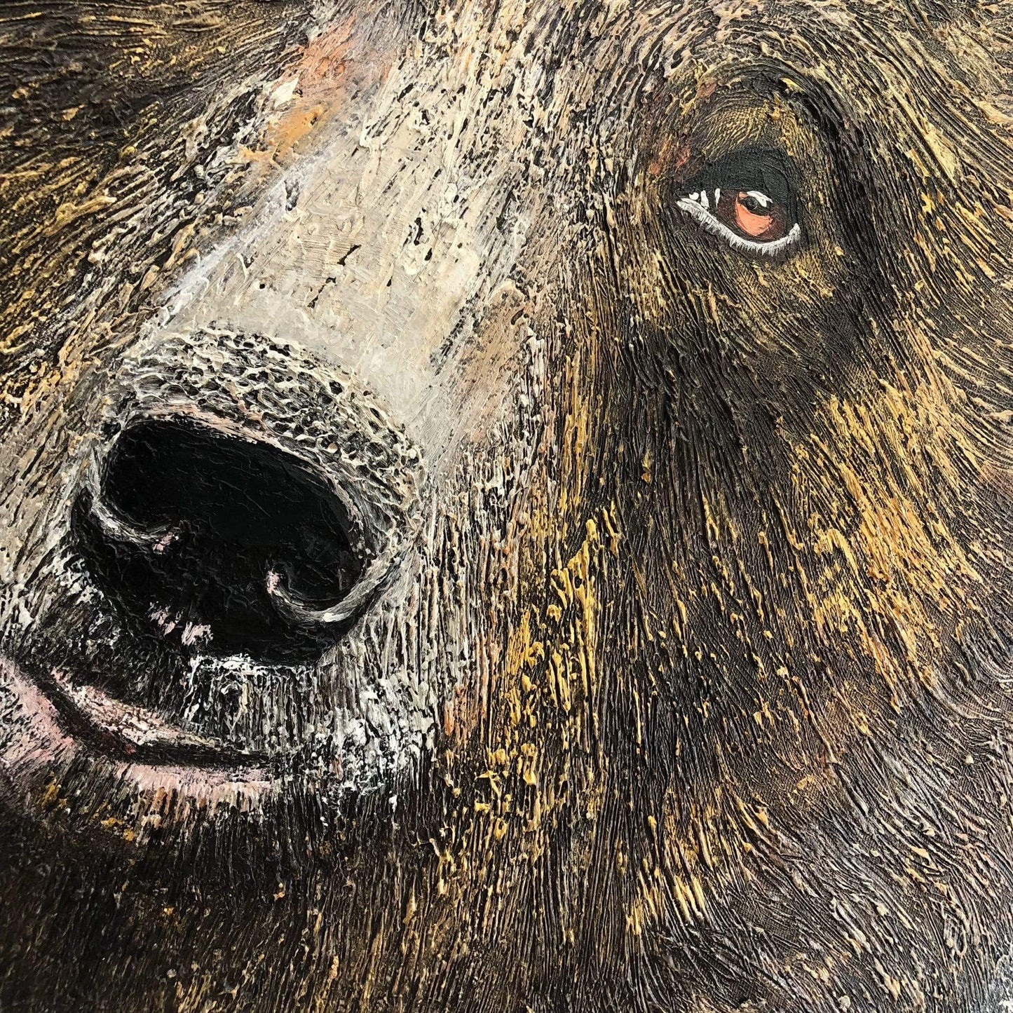 a close up of a brown bear's face