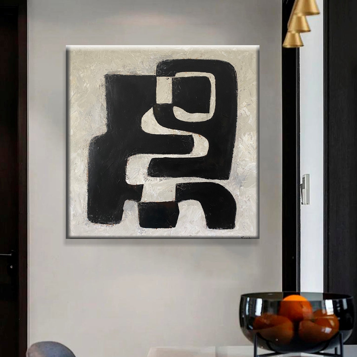 a black and white painting hanging on a wall