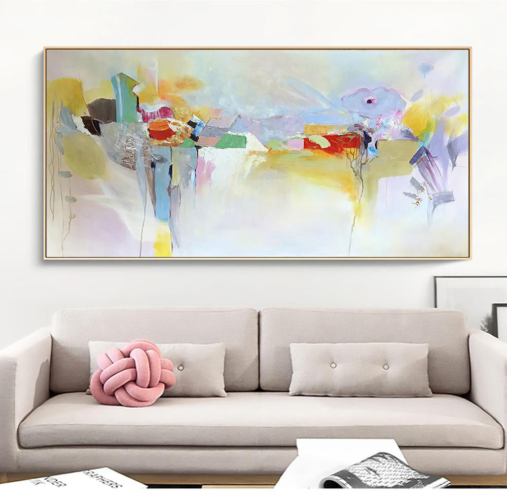 a living room with a couch and a painting on the wall