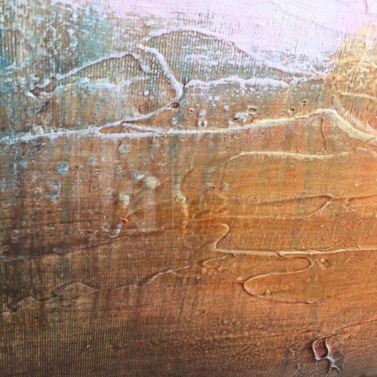 a close-up view of a textured surface, possibly a wooden or metal material, with a mix of orange, brown, and green colors. The surface appears to be weathered and has some areas of peeling or chipping paint, giving it a worn and aged appearance.