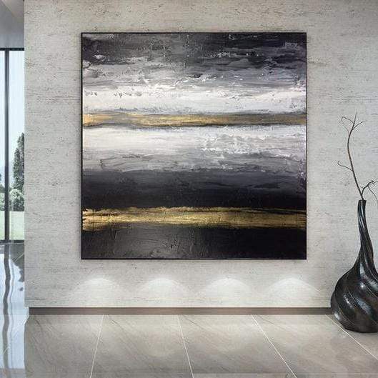 a large black and white painting hanging on a wall