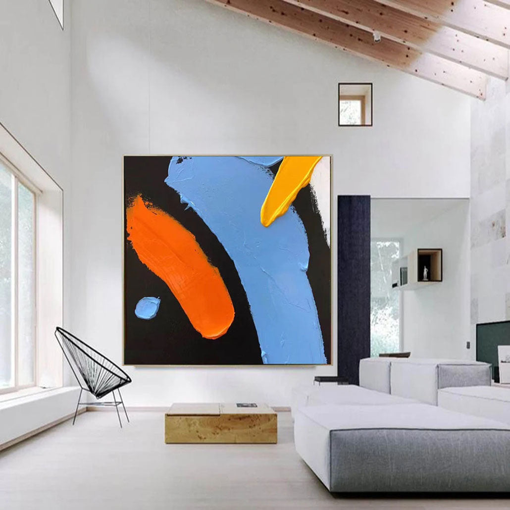 a living room with a large painting on the wall
