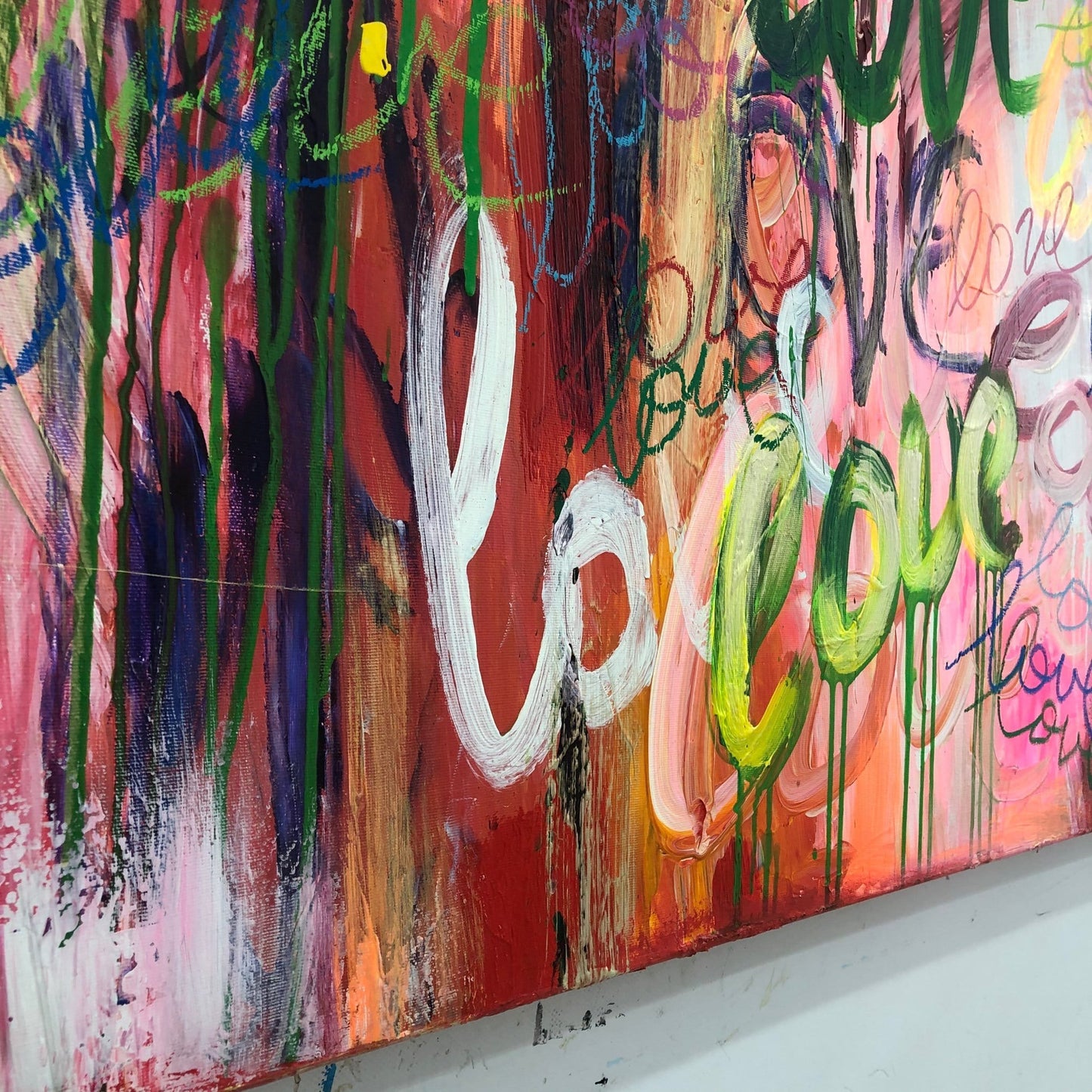The image is a vibrant and colorful abstract painting with bold brushstrokes and a mix of warm and cool colors. The painting features a variety of shapes and textures, creating a dynamic and visually engaging composition.