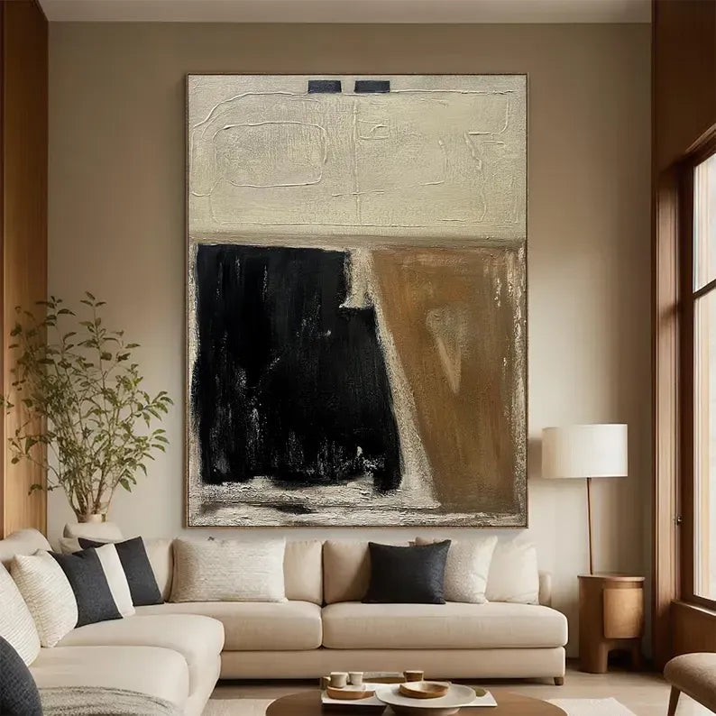 a modern living room with a large abstract painting hanging on the wall above a beige sectional sofa.