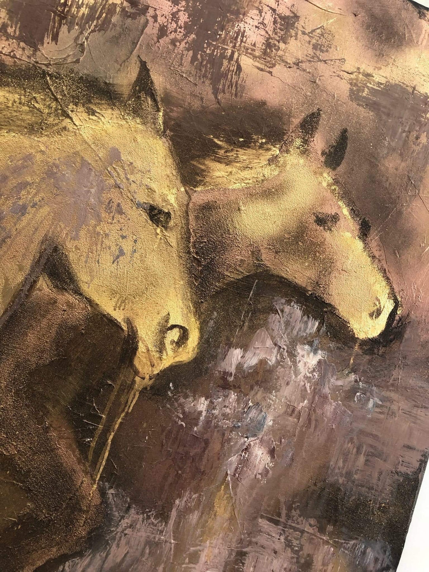 a close up of a painting of two horses