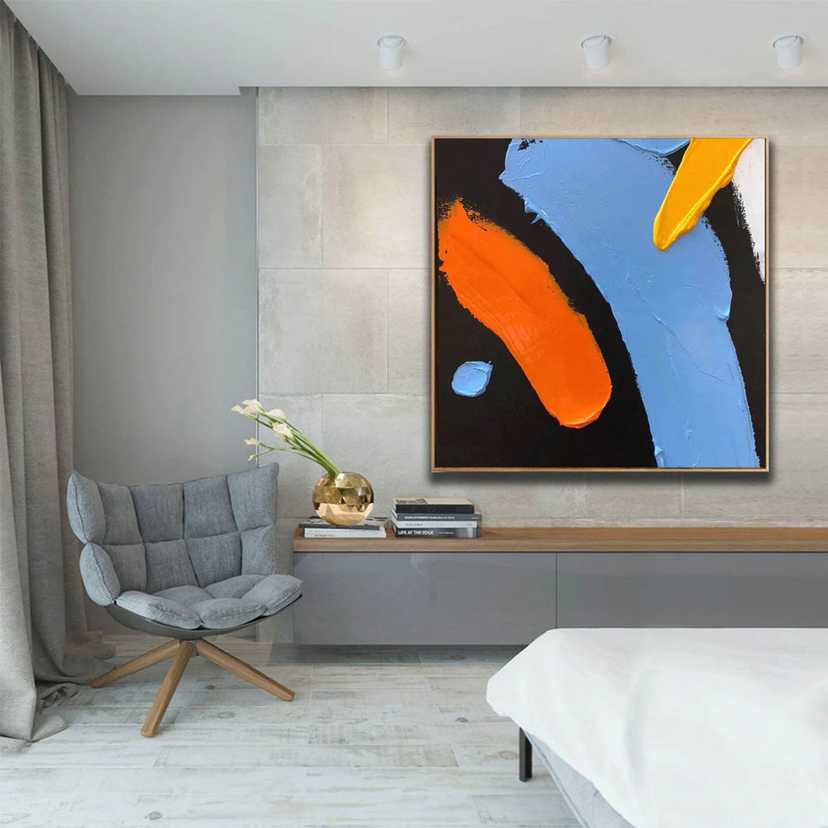 a bedroom with a bed and a painting on the wall