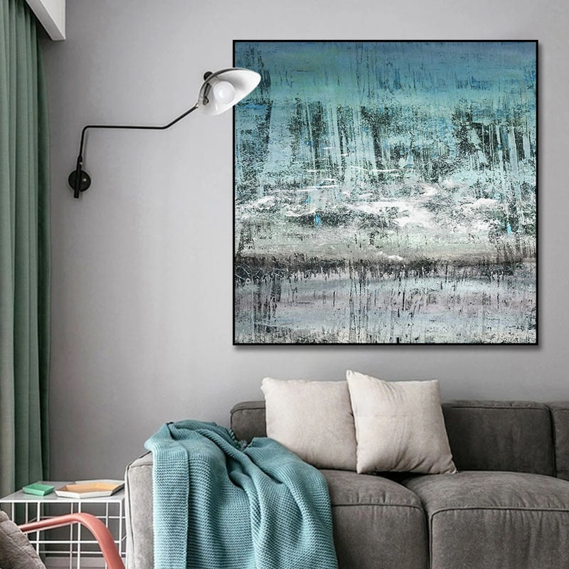 a living room with a couch and a painting on the wall