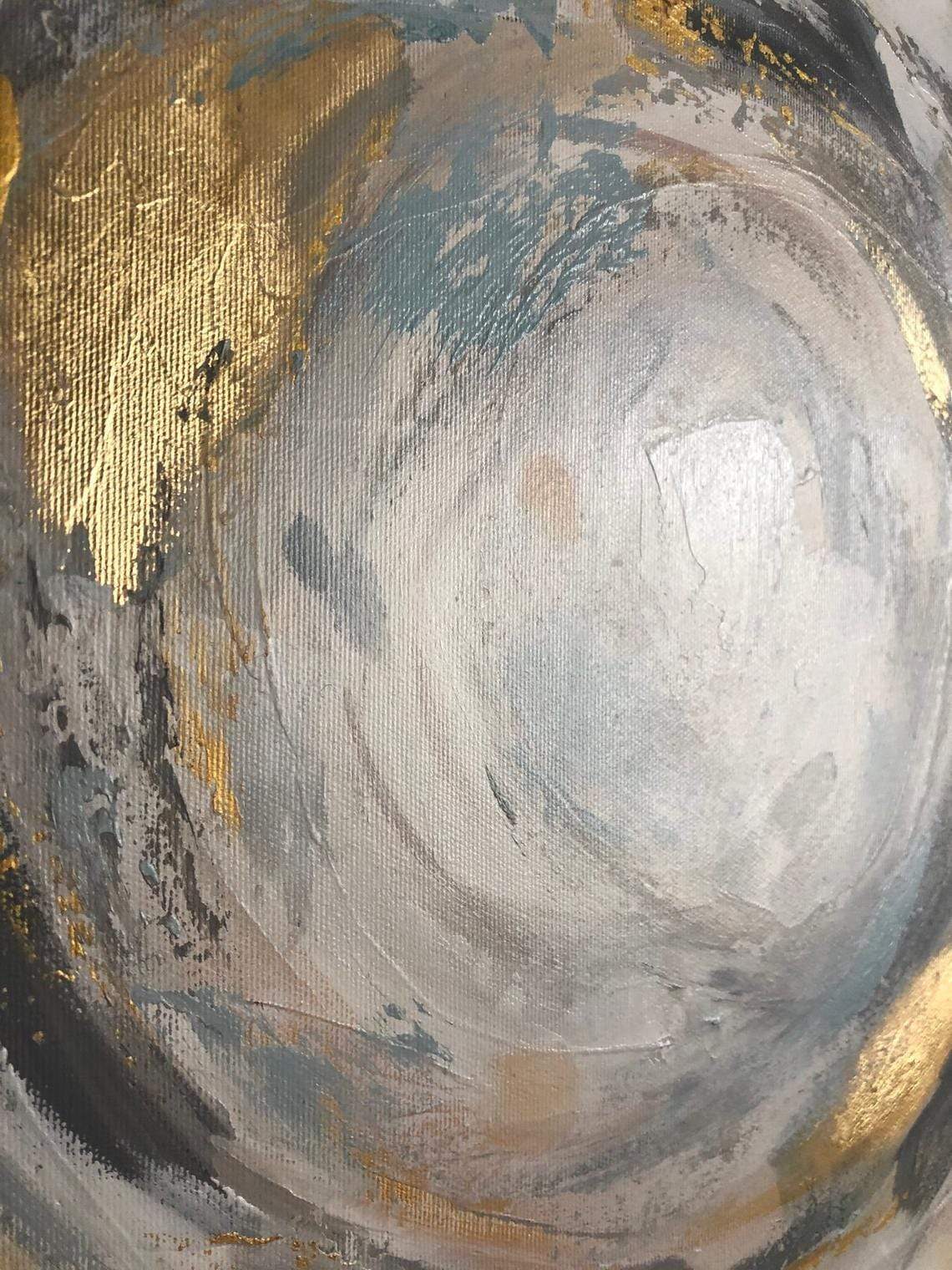 a close up of a gold and silver painting