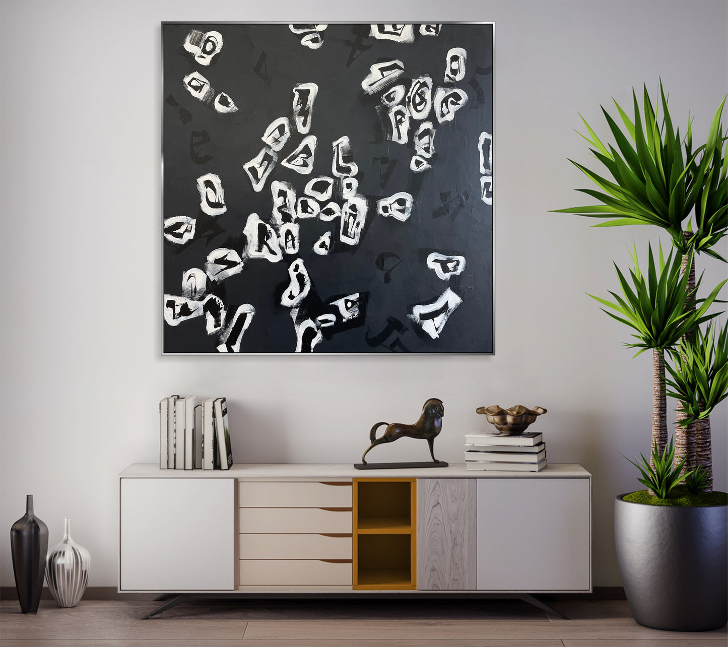 a black and white painting hanging on a wall