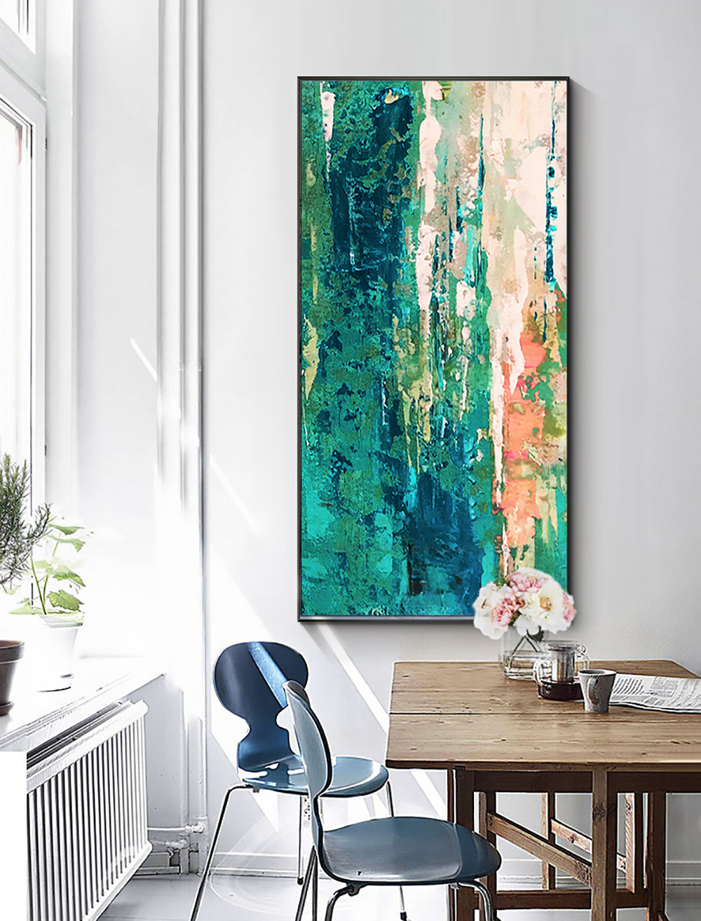 a painting hanging on a wall above a wooden table