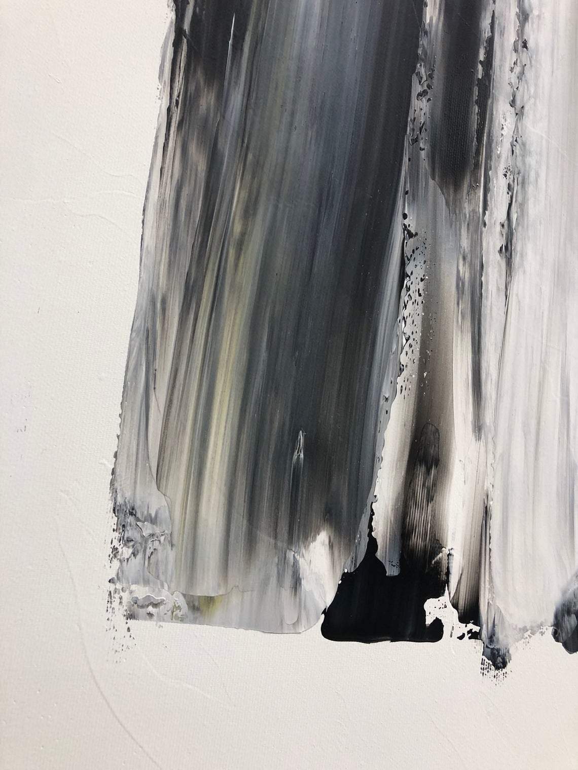 a painting of black and white paint on a white wall