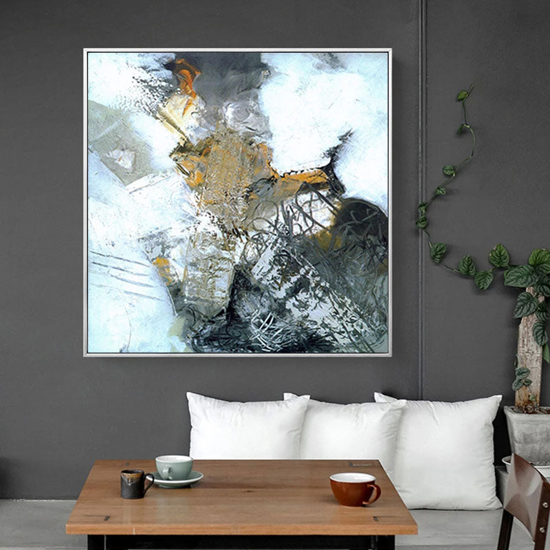 a living room with a coffee table and a painting on the wall