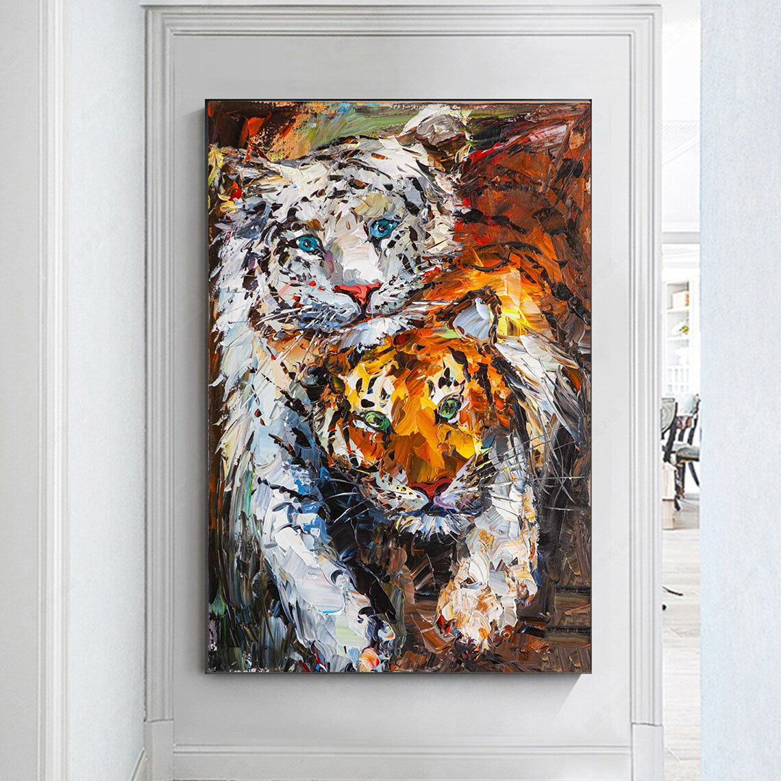 a painting of two tigers on a white wall