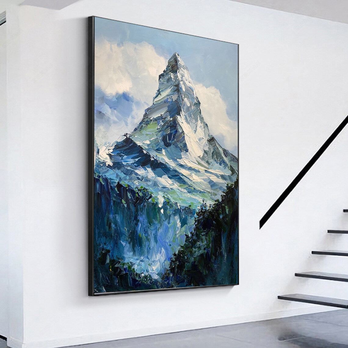 a painting hanging on a wall next to a stair case