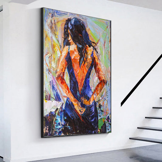 a painting of a woman is hanging on a wall