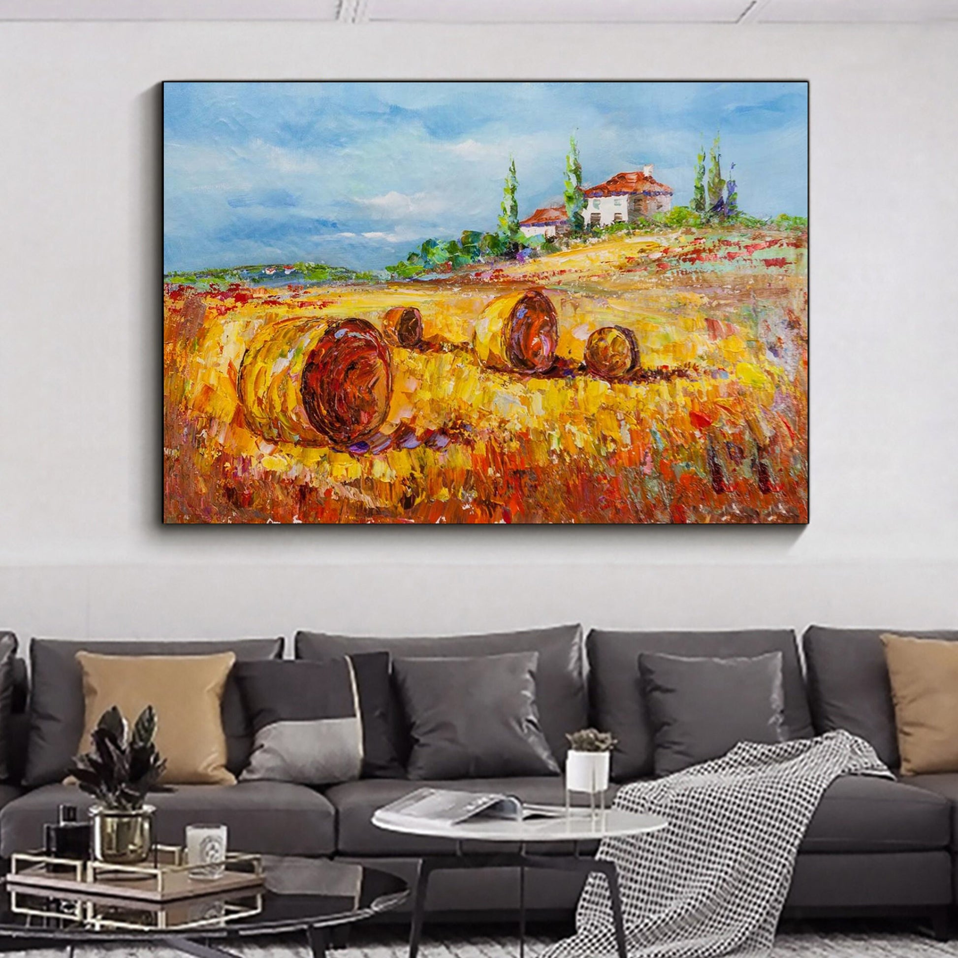 a living room with a couch and a painting on the wall